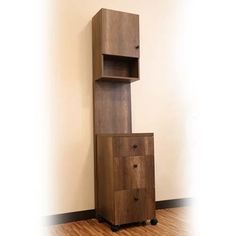 a tall wooden cabinet sitting on top of a hard wood floor next to a wall