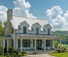 a large white house with lots of windows on the front and side of it's roof