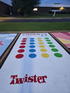 two rows of colorful painted parking meters with the word twister written on one side