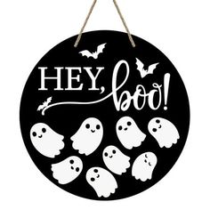 a black and white sign that says hey boo with ghost faces on it, hanging from a rope