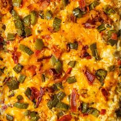 a casserole dish with cheese, bacon and green peppers on the top is ready to be eaten