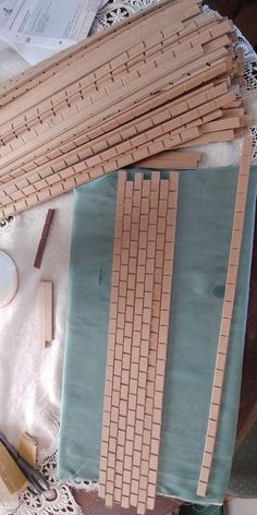 several pieces of wood sitting on top of a table next to scissors and other crafting supplies