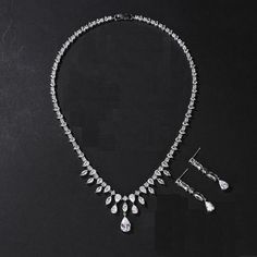 High Quality CZ Bridal and Formal Jewelry Set Add an elegant touch of sparkle to your wedding day or special occasion with this 5A quality CZ necklace and drop earring set. This platinum silver plated jewelry set glistens with brilliant round, teardrop and marquise shaped CZ crystals. The lovely drop design will add a romantic touch to your special day. Size: The necklace is about 17 1/3" long and the pierced earrings are about 1 1/2" long. Color: Silver/ Clear. Style: ne0835. Please allow 3 weeks for delivery. Shipping Policy . Return Policy Beaded Edge Veil, Quinceanera Accessories, Winter Wedding Accessories, Gold Bridesmaid Jewelry, Beaded Wedding Veils, Fingertip Wedding Veils, Rose Gold Bridesmaid, Veil Accessories, Formal Jewelry