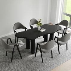 a black table with six grey chairs around it