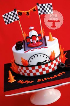 a red and white cake sitting on top of a table