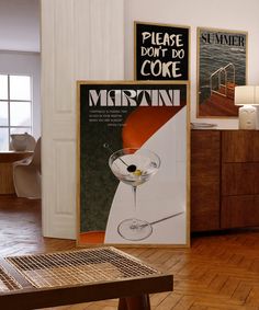 an advertisement for martini on the wall next to a table with a glass in it