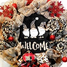 a welcome wreath with leopard print and red berries on the front, decorated with burlocks