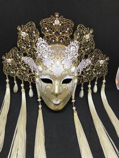 Venetian Mask for decoration - Traditional and original papier-mache Venetian mask, handmade and decorated with metal insert, gold-leaf and glitters, enriched with Swarovski crystals. Dimension::Hight 35cm,width 28cm Decoration only,not wereable All our masks are handmade paper-machè masks made in Venice. Our decorators use techniques typical of the Venetian tradition such as stucco, acrylics, gold and silver-leaf, macramè, passementerie, glitters and crequelè to offer you a wide range of origin Gold Carnival Eye Mask, Elegant Gold Mardi Gras Masks, Elegant Gold Mask For Masquerade, Gold Fantasy Headpieces For Masquerade, Elegant Gold Theater Masks, Gold Mask For Mardi Gras, Elegant Gold Mask For Carnival, Gold Fantasy Mask For Costume Party, Elegant Gold Masks For Carnival