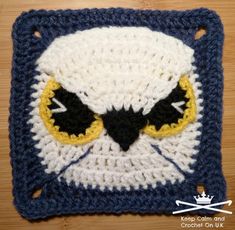 a crocheted square with an owl's face on it