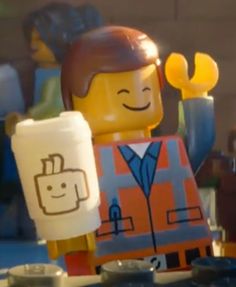 a lego man holding up a piece of paper