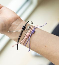 This dainty sailor bracelet features a flat gold bar charm strung on an adjustable length cord secured with a square knot. Makes the perfect friendship gift, and stacks well with other bracelets. Comes neatly packaged on a bracelet card. Currently available in 4 colors: Blush Lilac Storm grey Onyx