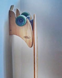 a surfboard mounted to the side of a wall with two paddles sticking out of it