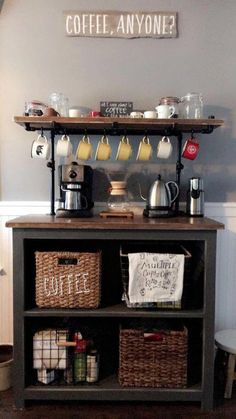 a coffee bar with baskets and cups on the top, next to a sign that says coffee anyone?