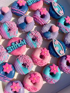 a box filled with lots of colorful donuts covered in frosting