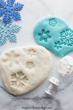 some snowflakes are on the table and one is made out of fondant