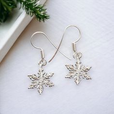 "A Pair of Sterling Silver Snowflake Earrings. Solid .925 Sterling Silver Construction. These Classic Snowflake Charm Earrings are both Cast and Assembled by us here in the USA. You'll receive a Pair. Solid Sterling Silver Construction Charm Size approx : 20mm x 14mm = 3/4+\" tall x 1/2+\" wide Metal : Solid .925 Silver | Solid Sterling Construction Made in the USA  Comes with care-card & Ready to Wear or Gift. Sold by : Pair SOLID STERLING SILVER These Earrings are made from Solid Sterling Silv Earrings Dangling, Snowflake Earrings, Silver Snowflakes, Christmas Gift For Her, Silver Christmas, Care Card, Christmas Gifts For Her, Charm Earrings, Solid 925 Sterling Silver