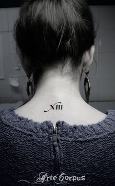 a woman's upper back neck tattoo with the zodiac sign virgo