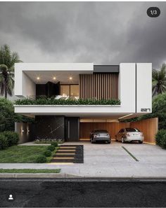 two cars parked in front of a modern house