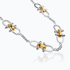 [especificaciones] Metal: Sterling silver with 23 karat yellow gold vermeil Dimensions: Length 17.3" Code: 01040300032 [/especificaciones][descripcion_producto]The Herencia Spurs Choker is part of a numbered limited edition of 80 units, made of sterling silver with 23 karat yellow gold vermeil. The versatile and timeless choker is made up of a series of equestrian-inspired elements interspersed by segments of silver chains. The modules, made by hand with a central articulation that allows the pe Luxury Metal Chain Necklace With Polished Finish, Luxury White Gold Jewelry With Hook And Links, Formal Sterling Silver Necklaces, Formal White Gold Necklaces With Hook And Links, Formal White Gold Necklace With Hook And Links, Formal White Gold Necklaces, Luxury Silver Jewelry With Hook And Links, 80th Anniversary, Silver Chains