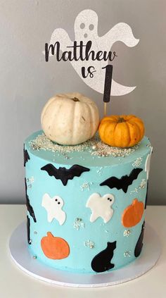 a blue cake decorated with halloween decorations