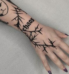 a woman's hand with barbed wire on it and the word love written in black ink