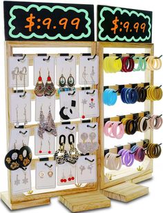 a display case with earrings and earring hooks on it's sides for sale