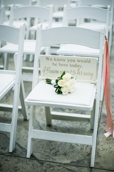 two white chairs with flowers on them and a sign that says we know you would be here today