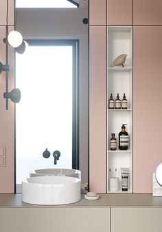 a bathroom with pink walls and shelves filled with personal care products on the counter top