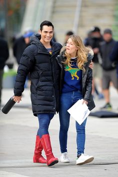 a man and woman walking down the street