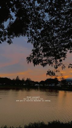 the sun is setting over a body of water with trees in front of it and a quote written below