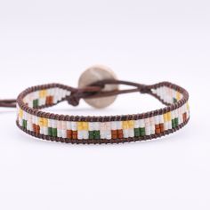 This single wrap leather bracelet is adjustable and has a second loop allowing some extra length.  Size: Adjustable from approx. 6.5-7in              >First Loop at approx. 6.5inches              >Second Loop at approx. 7inches Beads: Glass Seed Beads              >Matte White/Orange/Green/Pink/Yellow   Clasp: Coconut Button               >Brown Leather: Round Leather Cord              >Brown Thread: Nylon Upholstery Thread              >Brown *Photos are taken with care to ensure the color is portrayed correctly. However, due to different screen resolution, screen brightness, lighting, etc... from phone screens to computer screens, colors in the bracelet may differ slightly than pictured. If you have any questions, please don't hesitate to message me. Adjustable Hand Wrapped Leather Bracelet With Round Beads, Adjustable Hand-wrapped Beaded Leather Bracelet, Trendy Adjustable Wrap Bracelet For Festival, Everyday Multicolor Waxed Cord Jewelry, Bohemian Adjustable Leather Bracelet With Colorful Beads, Adjustable Bohemian Leather Bracelet With Colorful Beads, Multicolor Beaded Leather Jewelry, Adjustable Multicolor Leather Bracelet With Colorful Beads, Multicolor Beaded Bracelets On Waxed Cord As Gift