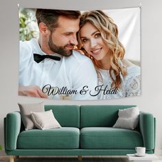 a man and woman are posing together in front of a wall tapestry that says william & hadi