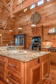 a large kitchen with wooden walls and flooring