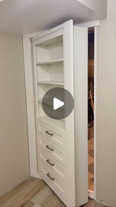 a white closet with drawers and shelves in it's corner, next to a door