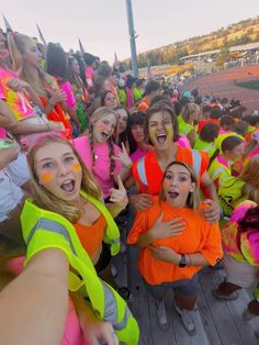 a group of girls in neon vests posing for the camera