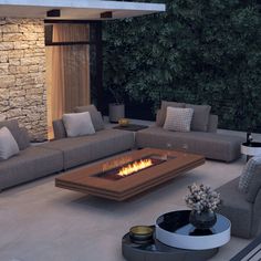 a living room with couches and a fire pit