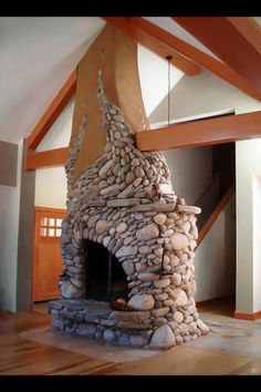 a fire place made out of rocks in a living room