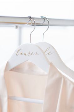 a wedding dress hanging on a hanger