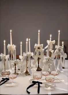 a table topped with wine glasses and candles