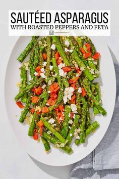 asparagus with roasted peppers and feta on a white plate