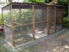 a small chicken coop in the middle of a yard