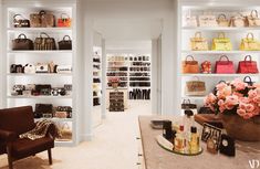 the inside of a women's store with shelves full of purses and handbags