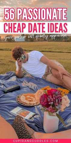 a man laying on top of a blue blanket next to a vase with flowers in it