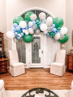 a room decorated with balloons and chairs