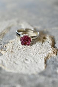 Raw Garnet Ring thats perfect for: January Birthstone Jewelry for Women, Garnet Birthday Ring, Birthstone Ring for January Tiny, raw garnet chips clustered together to form a blooming red lotus flower. Set on a bright silver colored band, flower leaf cup and wire wrapping, my signature design. Made to order, one size fits most. Gift giving ideas: January Birthday present for her, Graduation present for her, Anniversary jewelry for wife, Girlfriend gift, Mothers Day, Holiday gifts as well. SETTIN Flower Toe Ring With Stone Setting As Gift, Adjustable Gemstone Flower Ring For Anniversary, Anniversary Ruby Crystal Ring With Stone Setting, Adjustable Birthstone Ring With Stone Setting For Anniversary, Crystal Birthstone Toe Ring For Anniversary, Anniversary Birthstone Crystal Toe Ring, Anniversary Flower Ring With Stone Setting, Sterling Silver Cluster Ring With Birthstone For Gift, Open Cluster Ring With Accent Stones For Gift