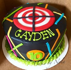 a birthday cake that is decorated with the number ten and has an arrow on it