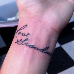 a person with a small tattoo on their wrist that says, grace and amanda in cursive writing