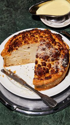 there is a pie on the plate with a slice missing from it and a knife next to it