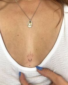 a woman's chest with a smiley face tattoo on it