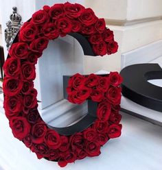 the letter g is made out of red roses